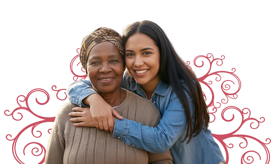 A smiling young woman in a denim shirt embraces an older woman wearing a headscarf and sweater against a black background, conveying warmth and love.