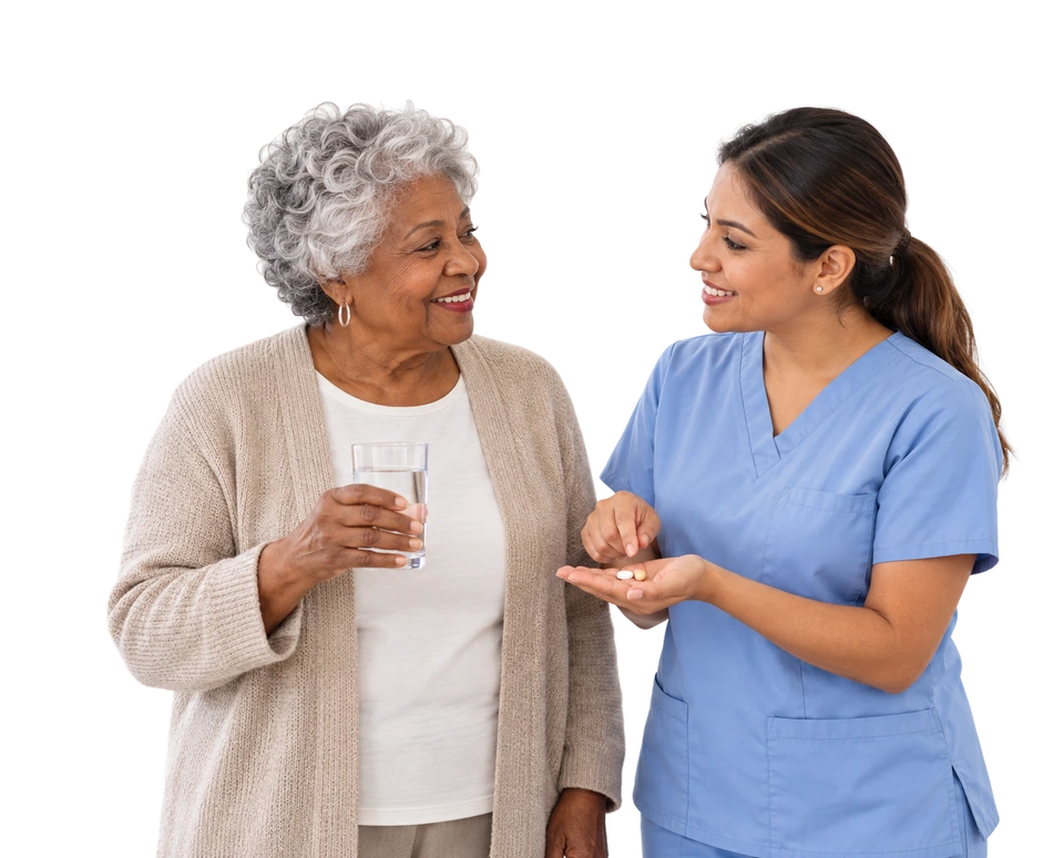 Caregiver offering an older woman a glass of water and medication